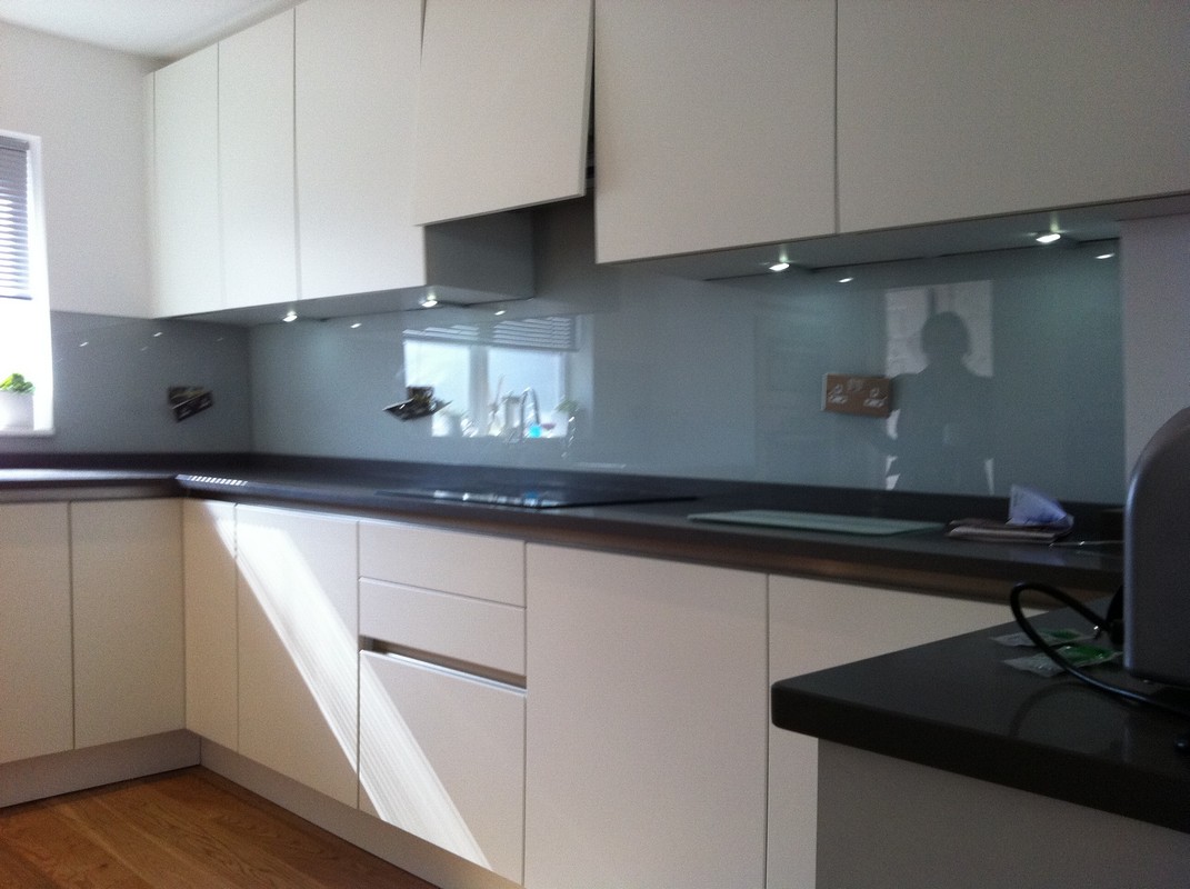 Grey glass kitchen splashback with LED lighting in Stockwell