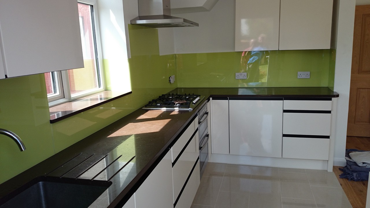 Lime green glass kitchen splashback installed by Stockwell glaziers