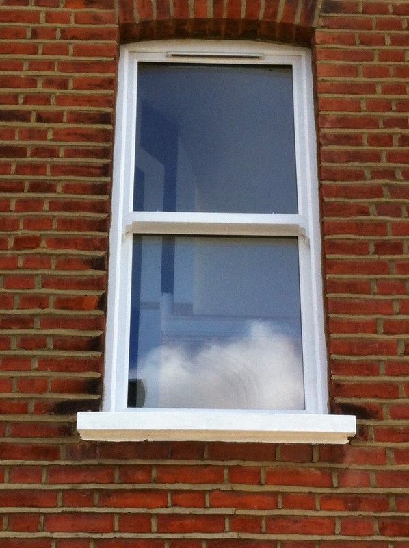 uPVC sash window on Victorian red brick house in Stockwell